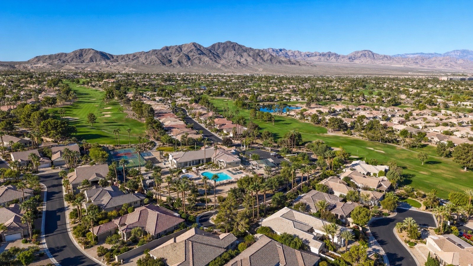 Las Vegas valley aerial view showing master-planned suburban neighborhoods and Spring Mountains backdrop 2026